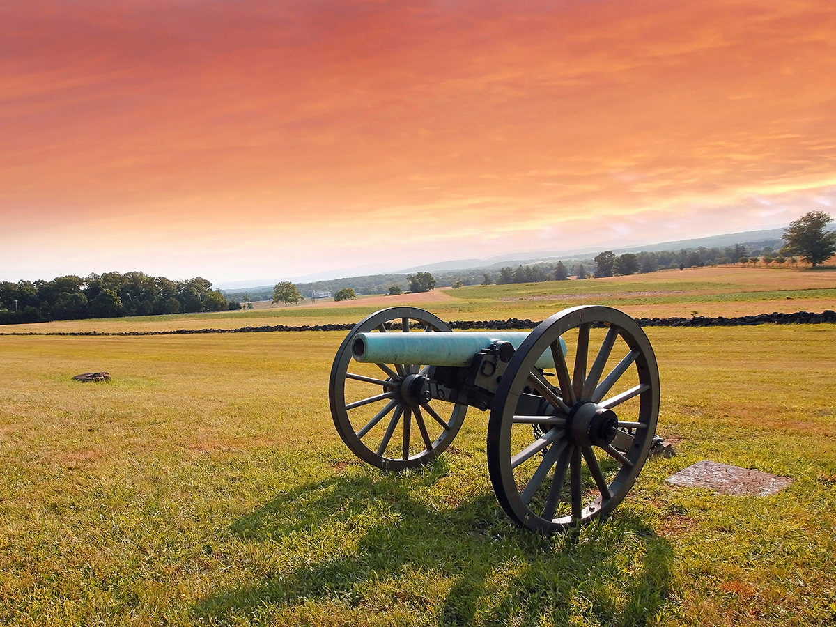 A Civil War era cannon sitting in the middle of a field at Gettysburg