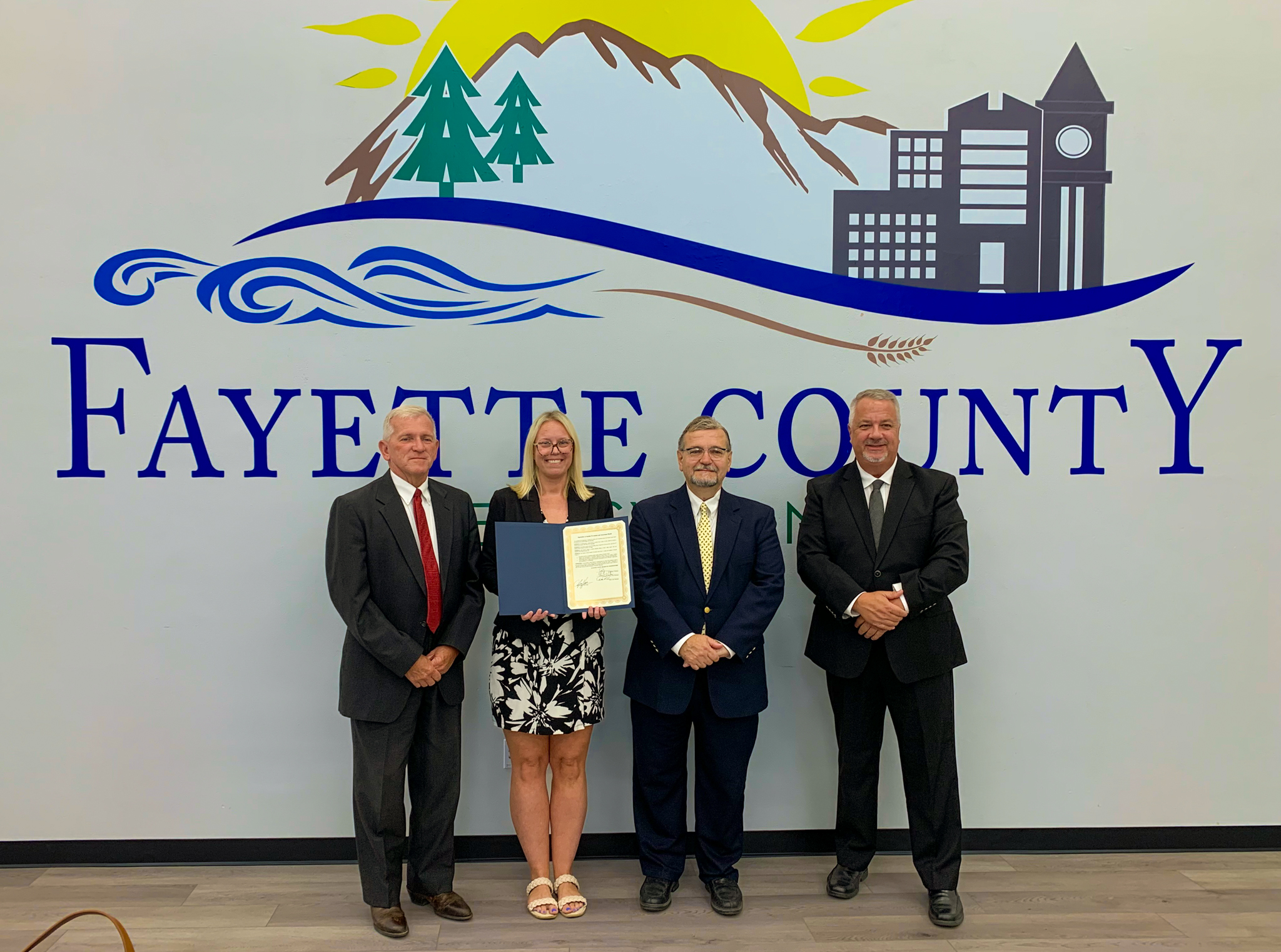 From left: Fayette County Commissioner and Secretary Dave Lohr, Penn State Fayette Mental Health Counselor Amanda Collins, Fayette County Commissioner and Vice Chairman Vince Vicites, and Fayette County Commissioner and Chairman Scott Dunn stand together after signing a proclamation recognizing September as Suicide Prevention and Awareness Month.