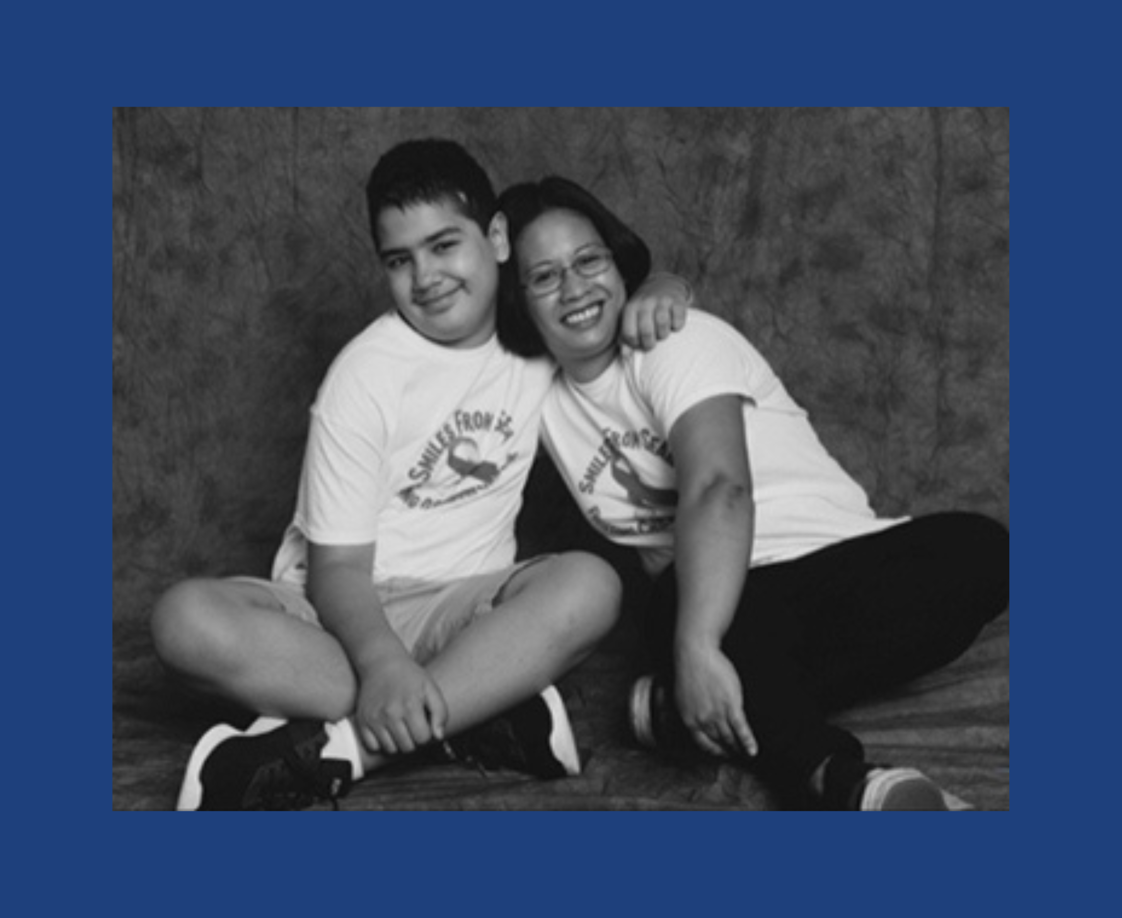 A teen and a woman sit together in a photography studio.