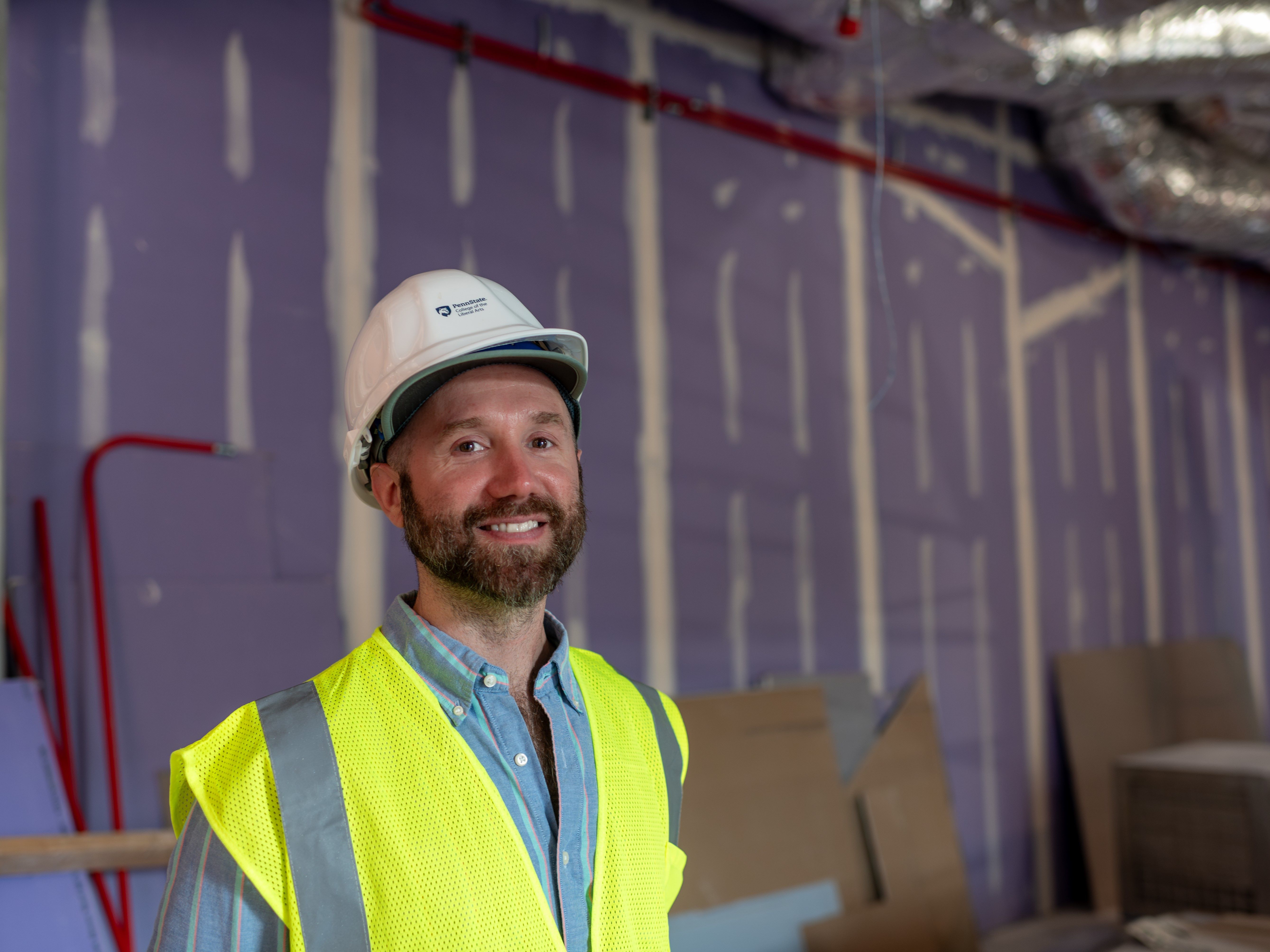 Photo of Matson Museum Director James Doyle wearing a hardhat and construction vest