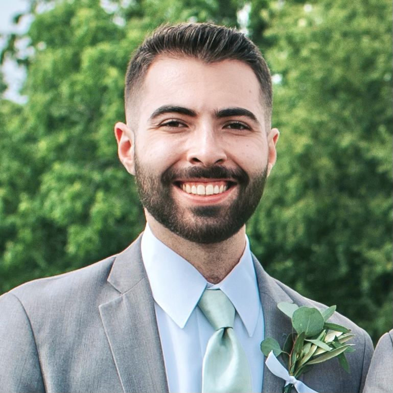 Portrait of Nicholas Palermo wearing a gray suit.