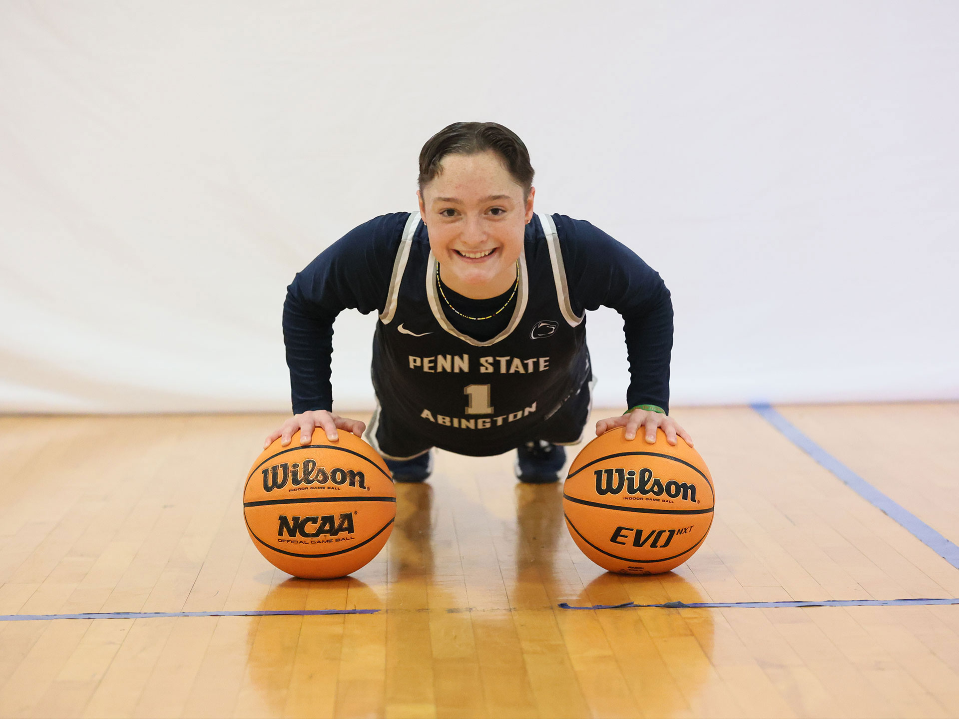 Athlete balancing on two basketballs