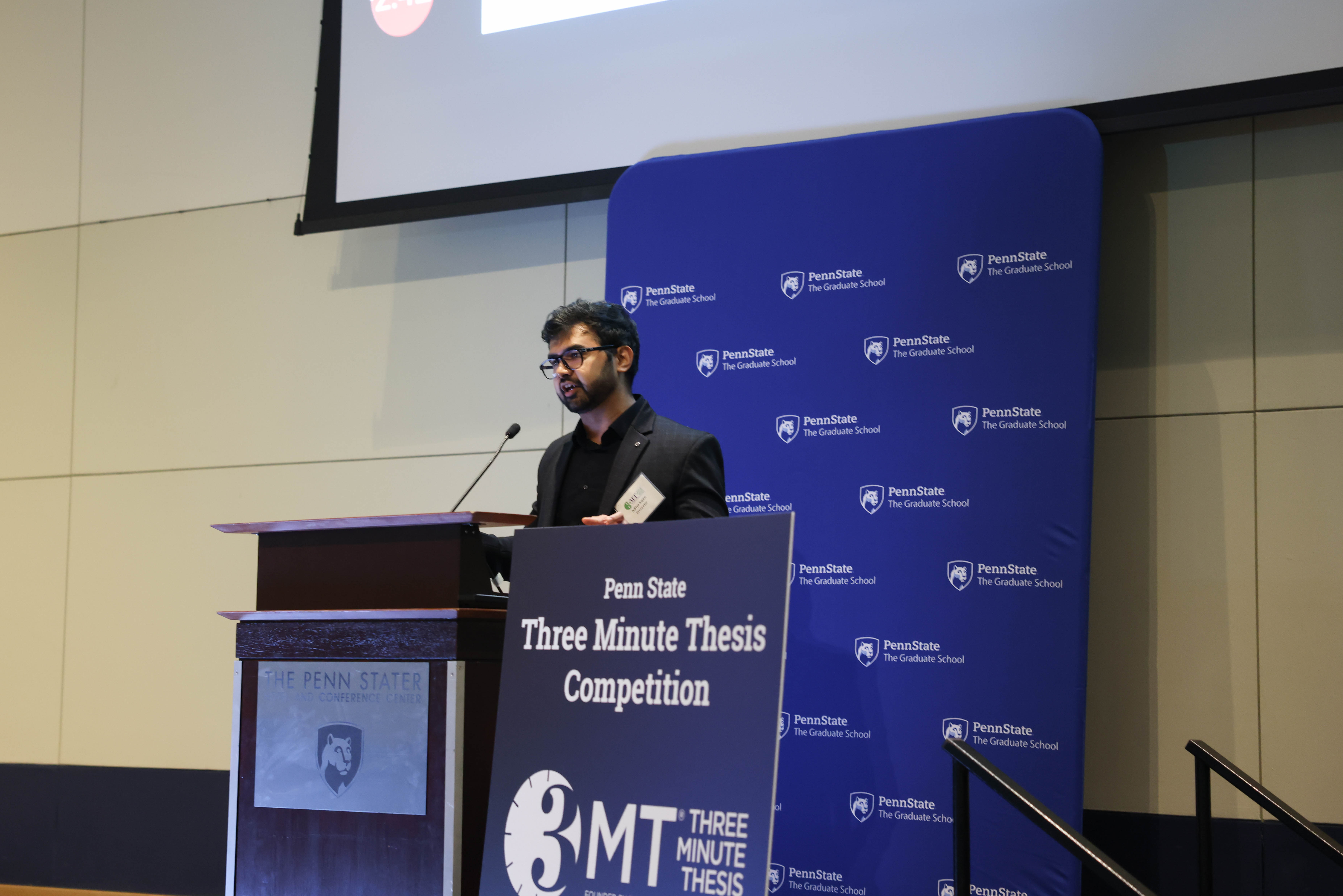 A person talks at a podium for an event