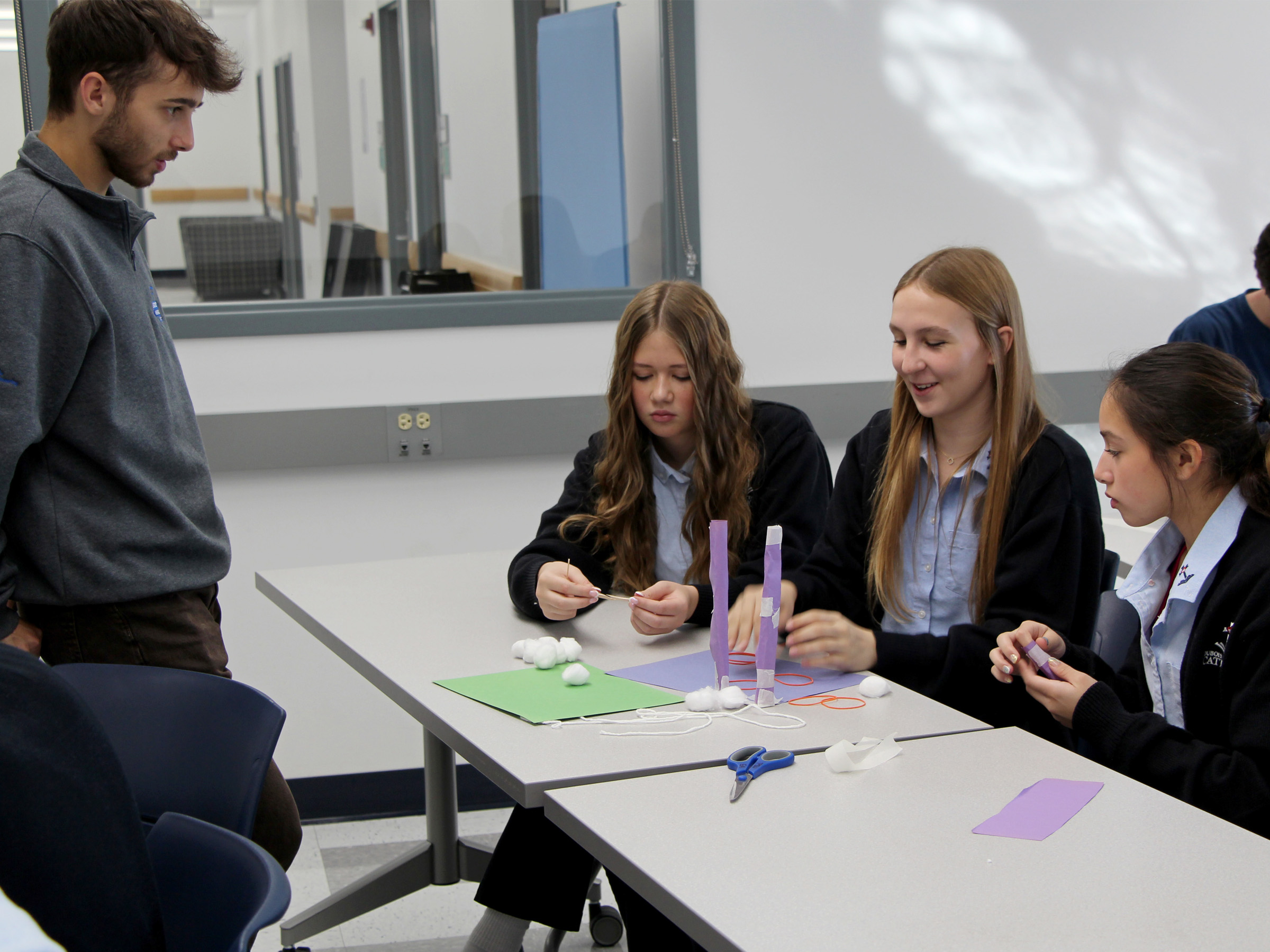 Students attending Discover Engineering Day at Penn State DuBois discuss their design ideas for a project with a member of the Engineering Ambassadors Program, who offered insights and suggestions on improvements.