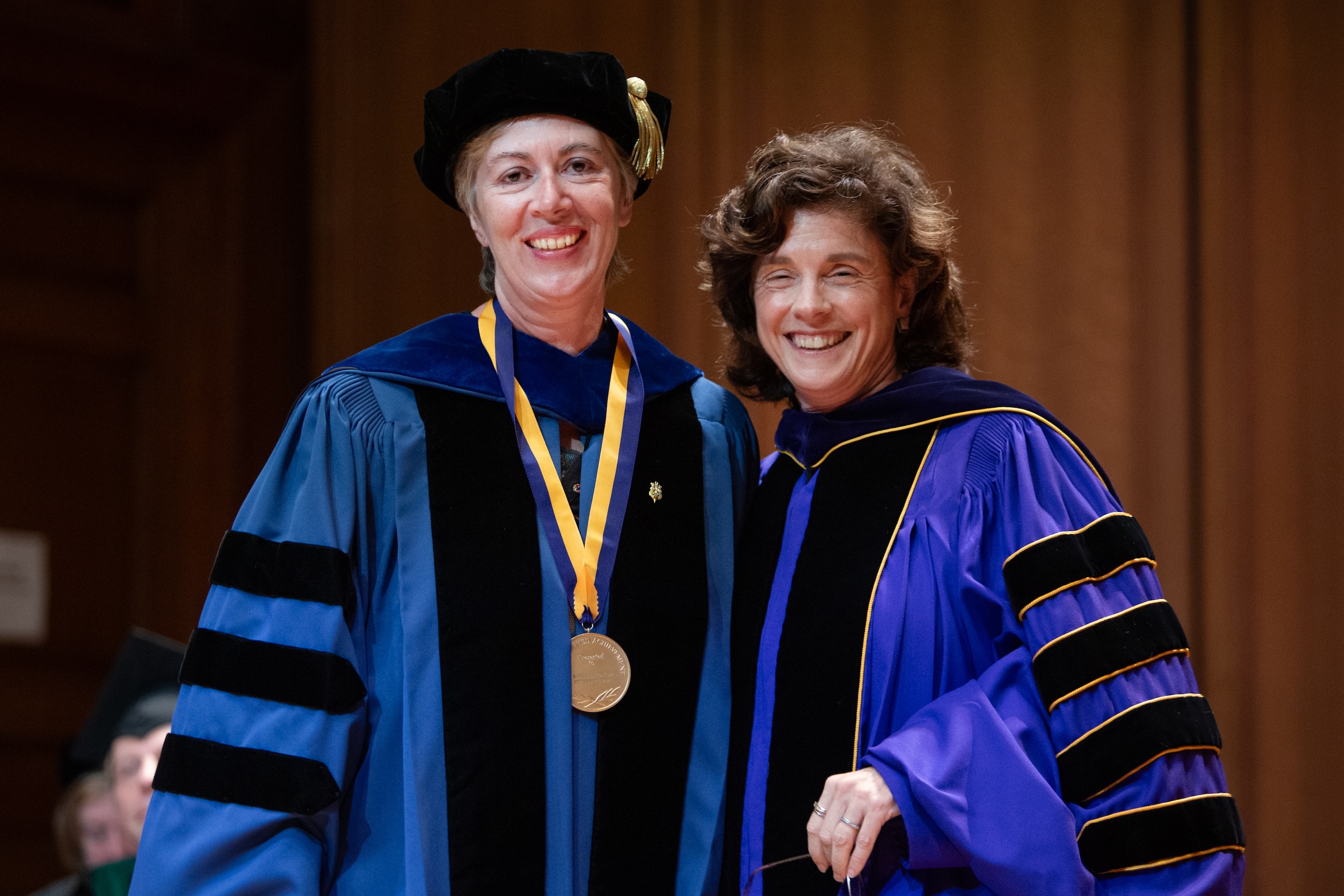 Two women in royal blue academic regalia