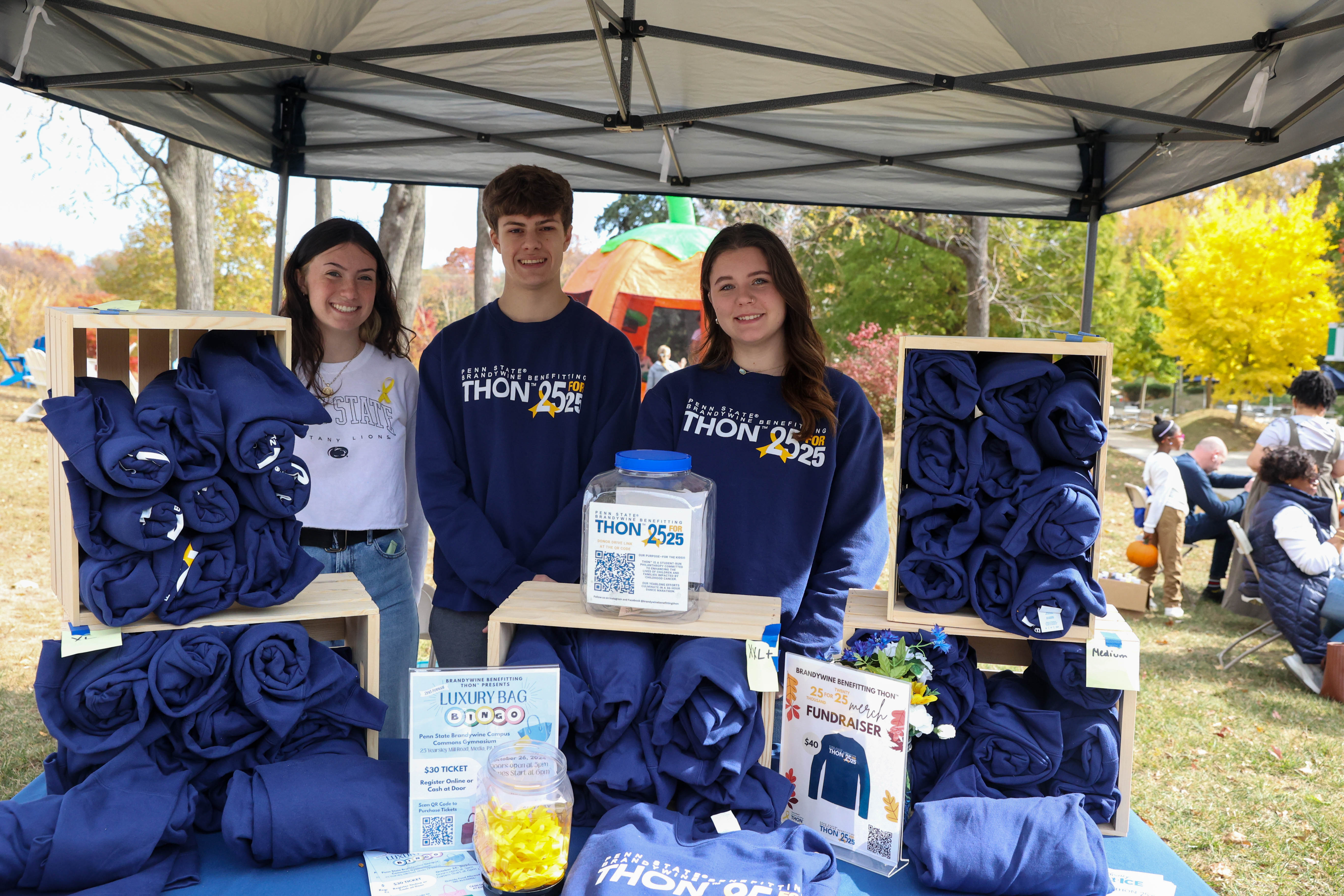 students selling THON sweatshirts