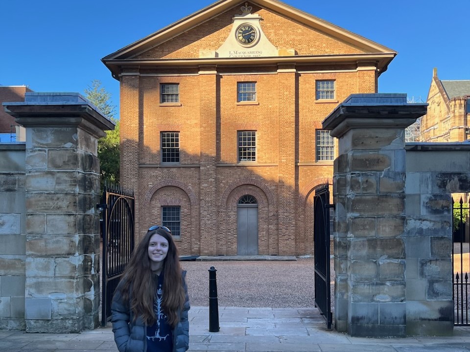 Headshot of Ashleigh McDonald standing outside a building 