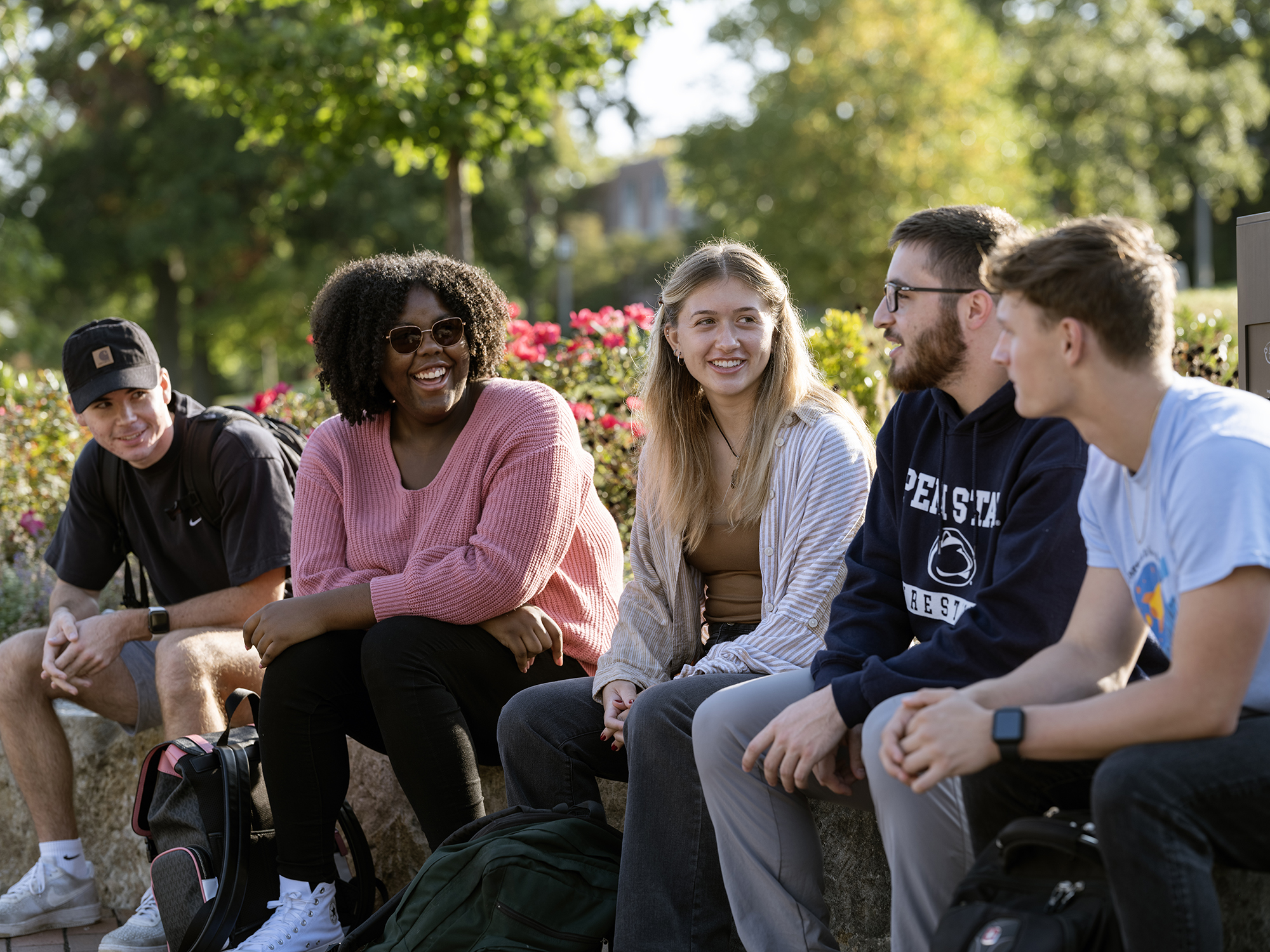 Students talk while sitting outside at Penn State Behrend.