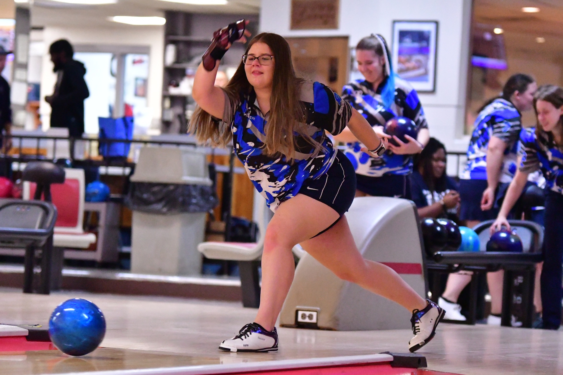 A member of the Penn State Behrend women's bowling team rolls the ball.