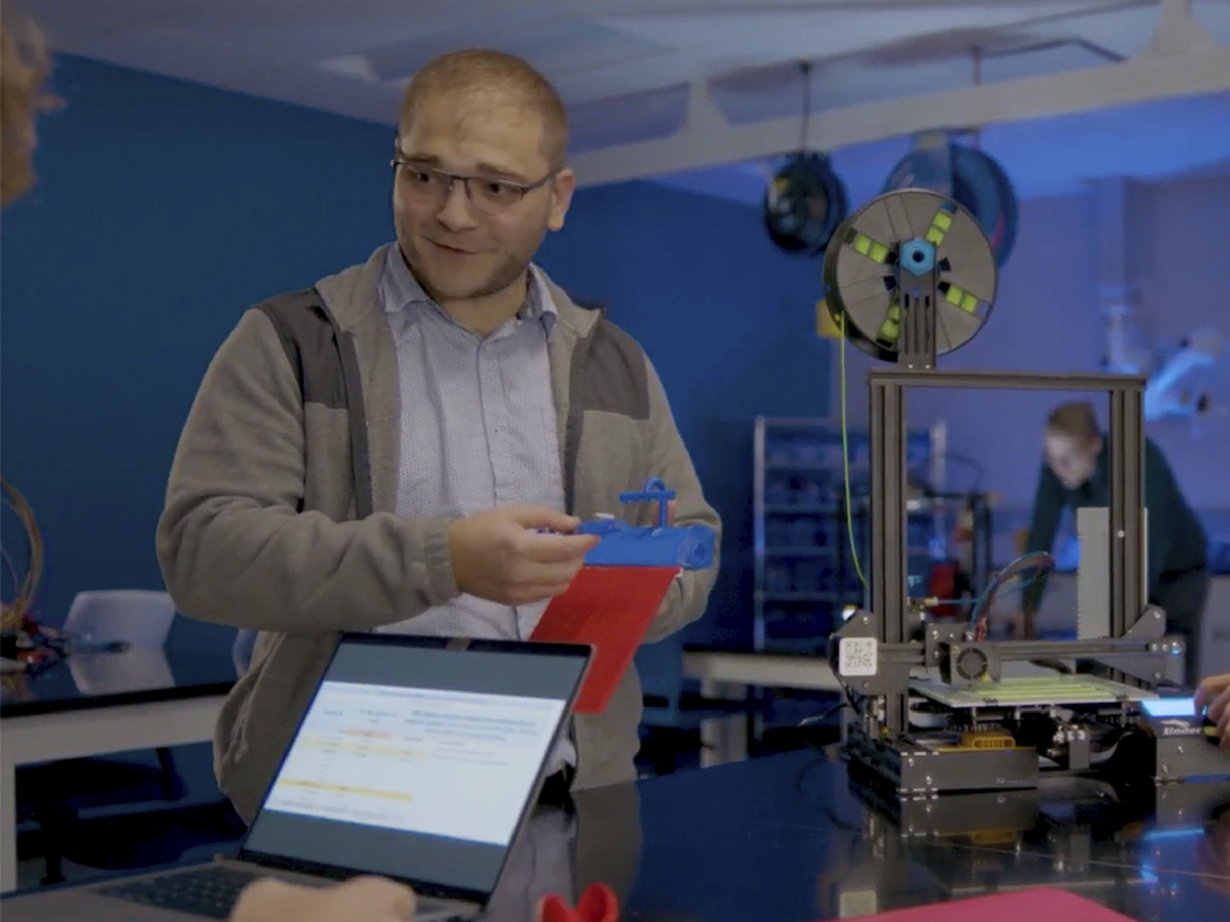 Matthew Caputo demonstrating how a 3D printer works