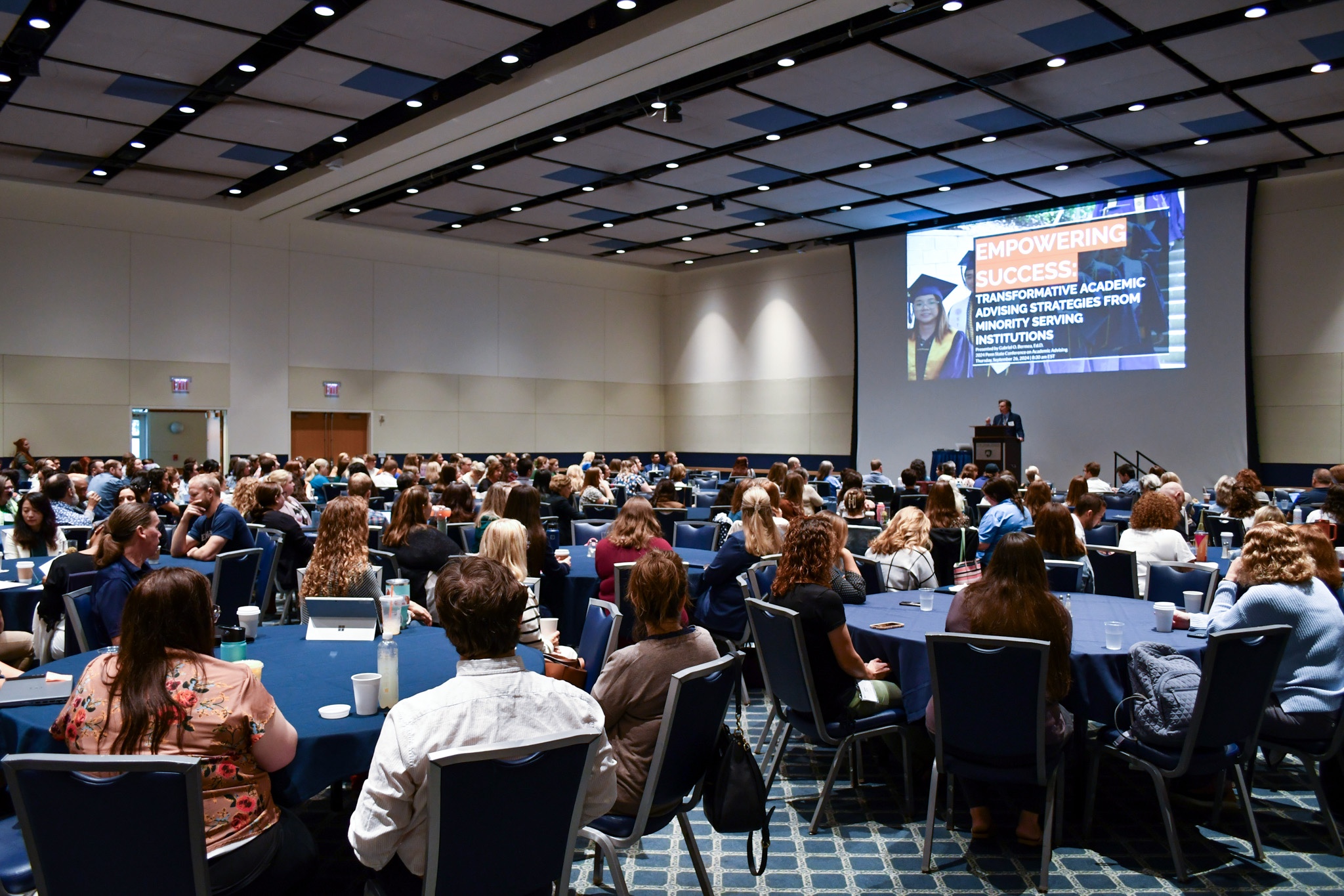 Photo of seated crowd attending an academic advising conference 