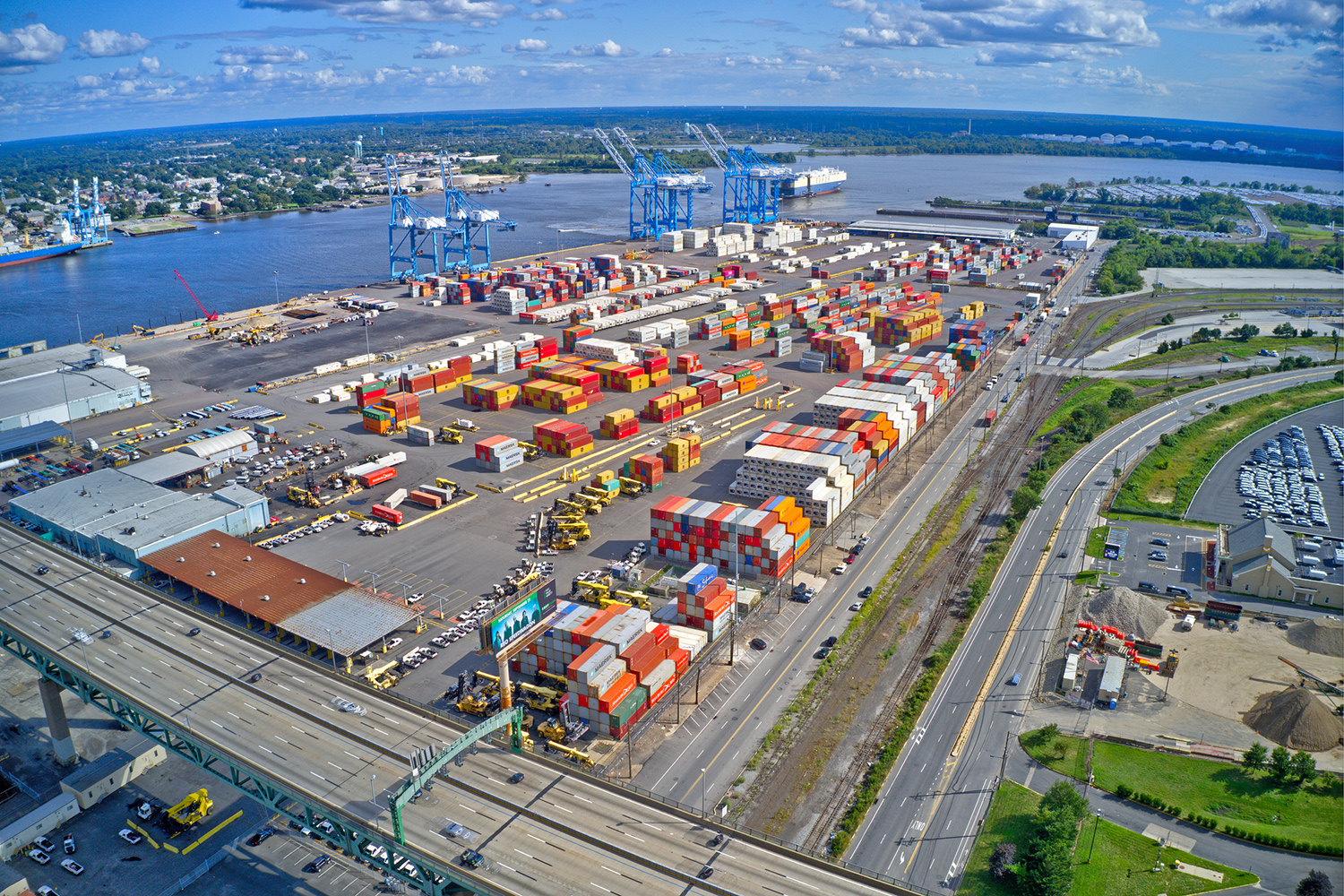 An aerial view of the Port of Philadelphia showing cranes and stacked containers