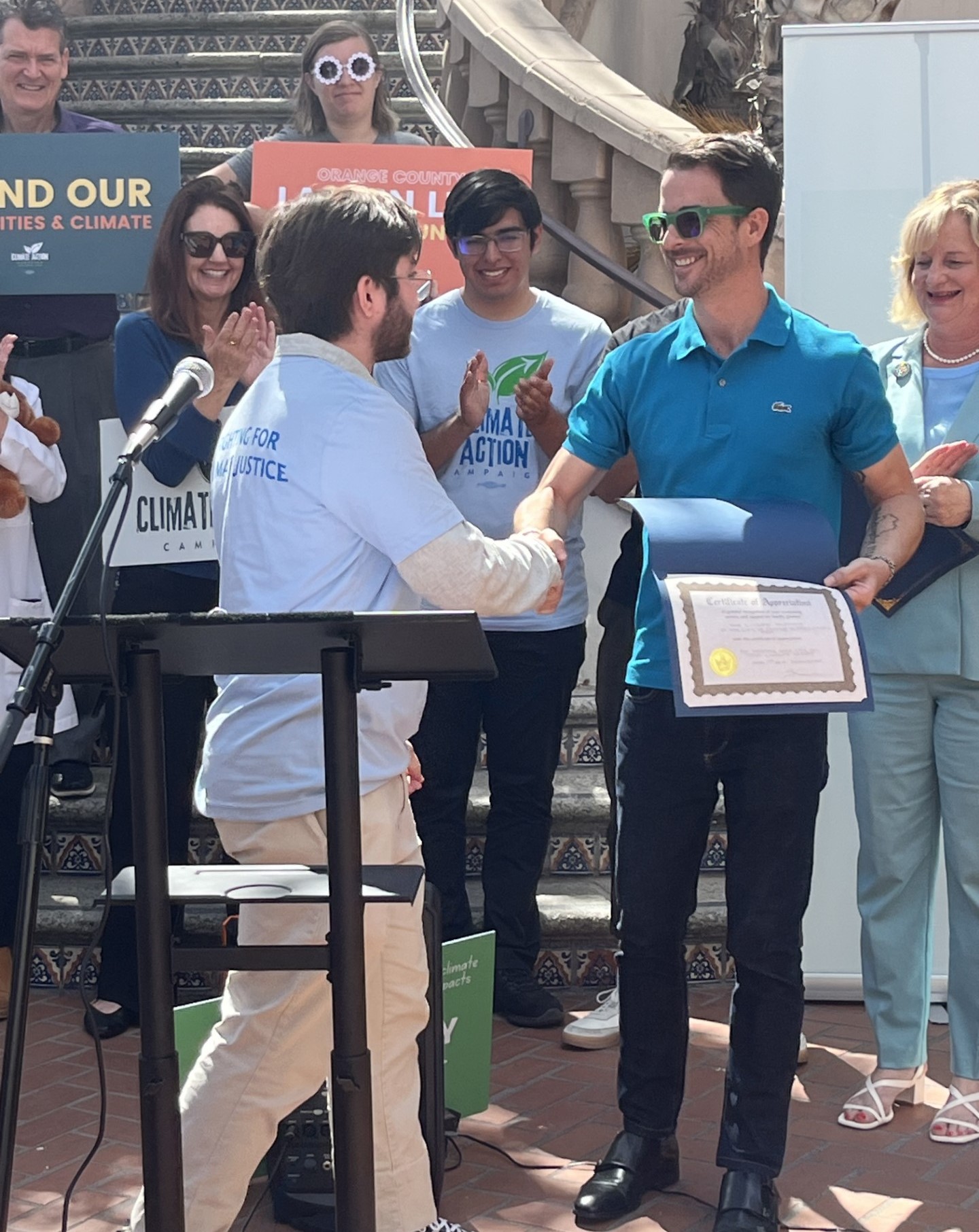 A man receives a certificate at a ceremony.