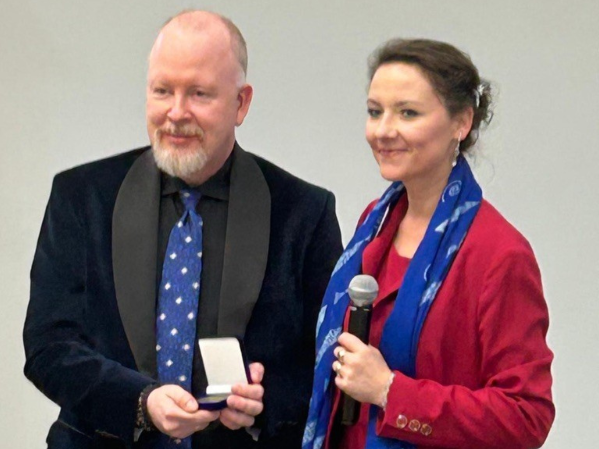 Brennan poses with the medal for a photo