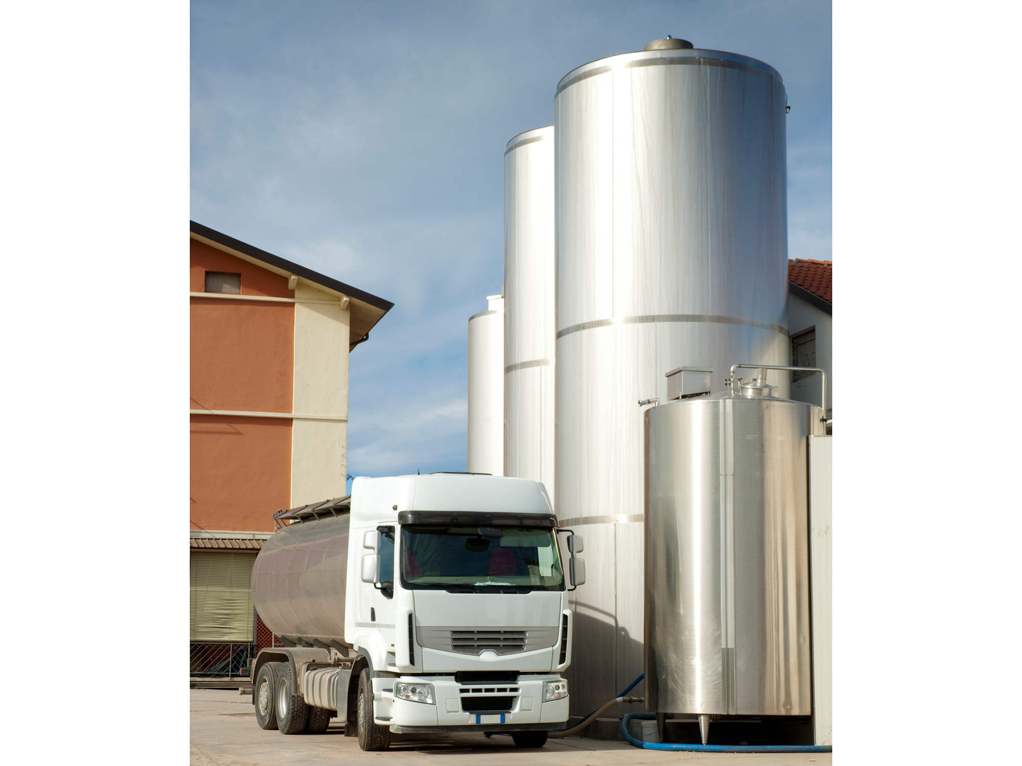 Truck parked outside milk tanks