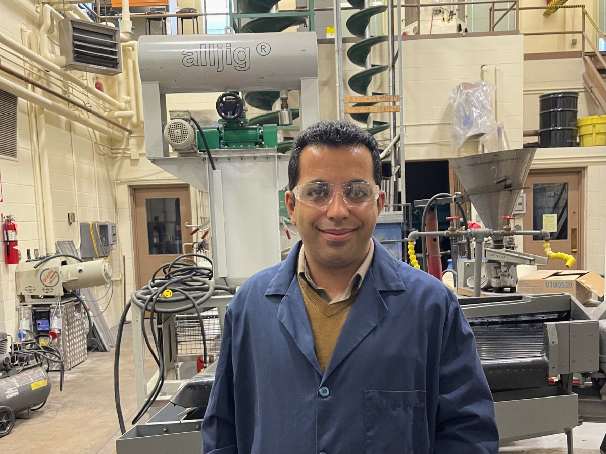 Mohammad Rezaee poses for photo in a recycling facility