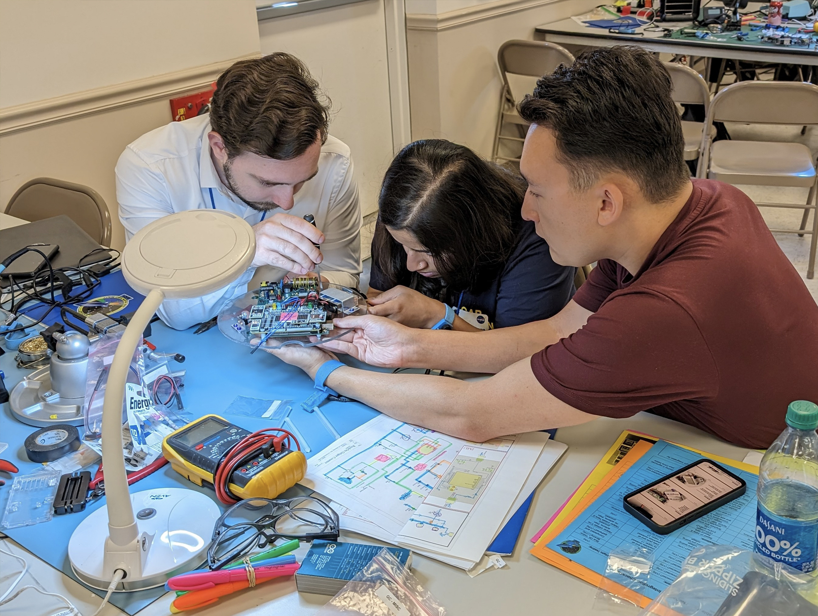 Three Penn State students work on a scientific payload for the NASA Rock On program