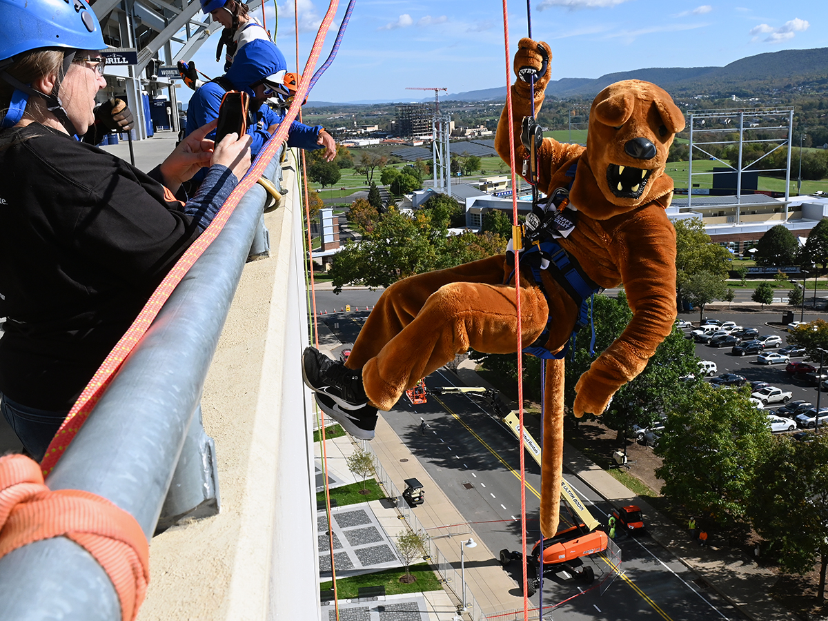 Nittany Lion mascot with ropes on side of Beaver Stadium