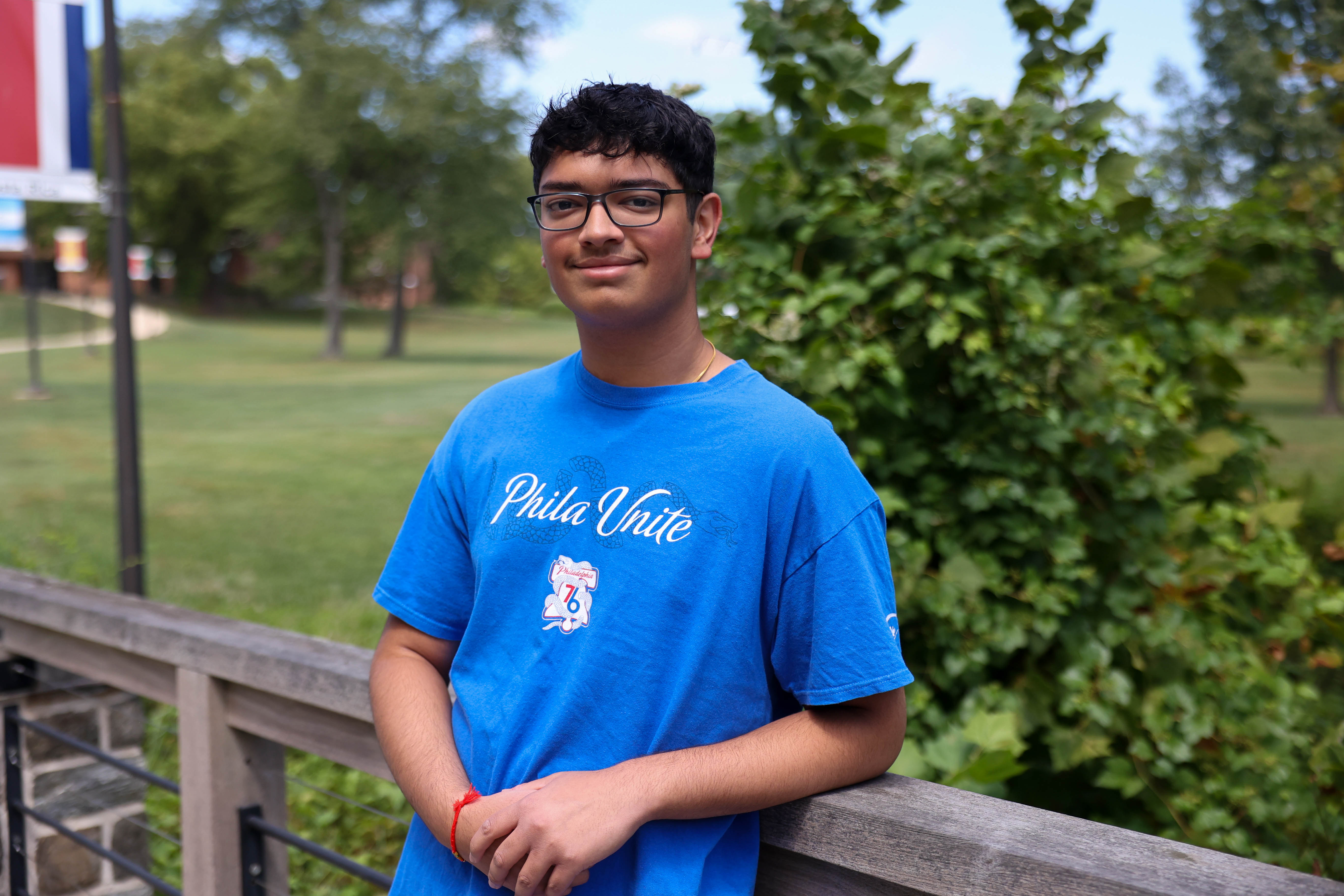 A male students stands on a sidewalk at the Penn State Brandywine campus.