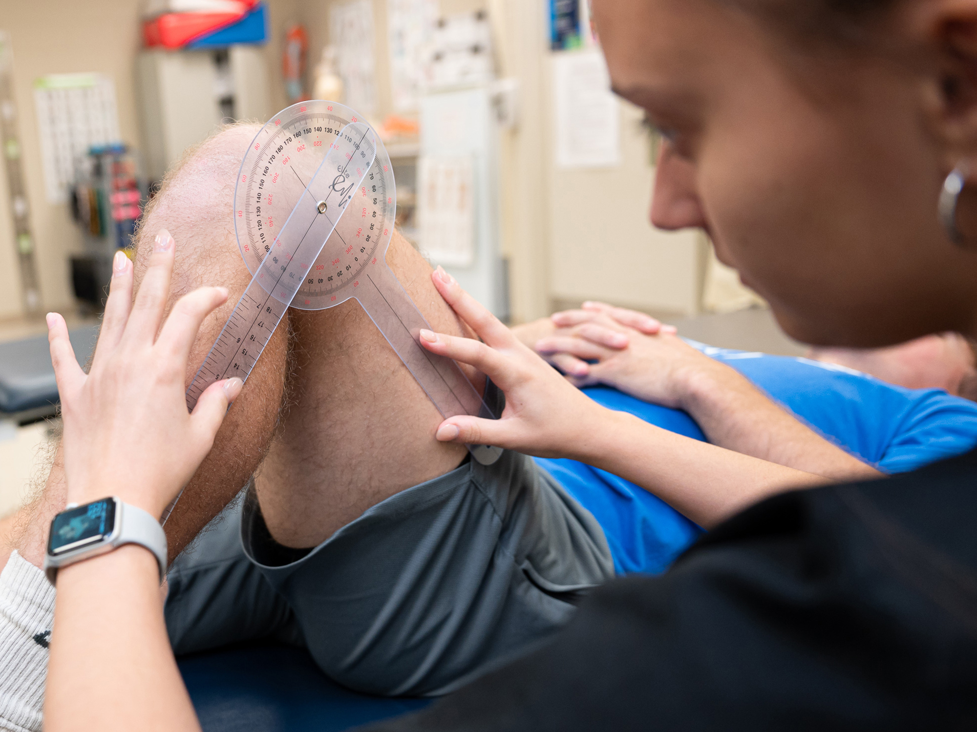 A student in Penn College's physical therapist assistant program practices her skills on a patient's leg.