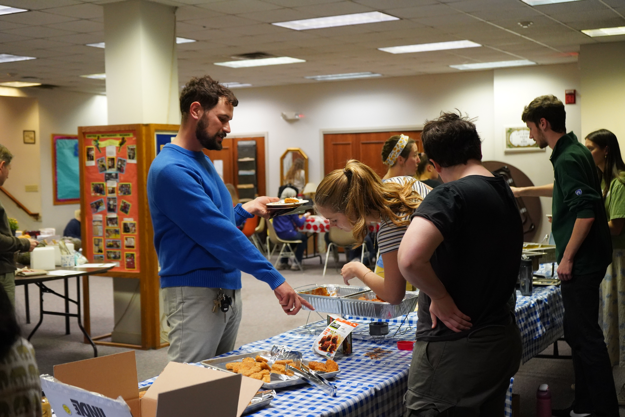 A student attending Plant Powered PSU asks a question about a food sample