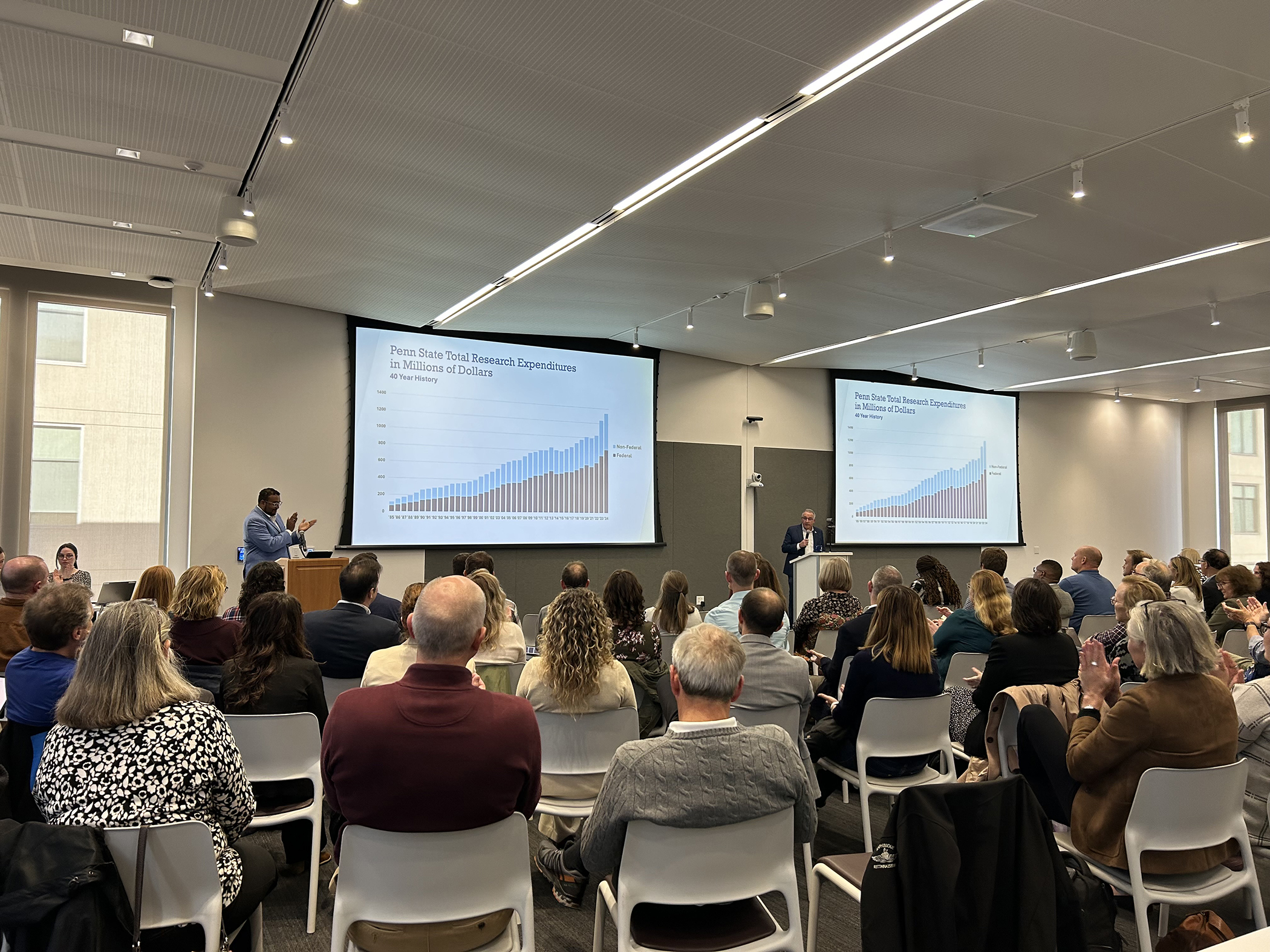 A person gives a presentation to a group of people in a conference room