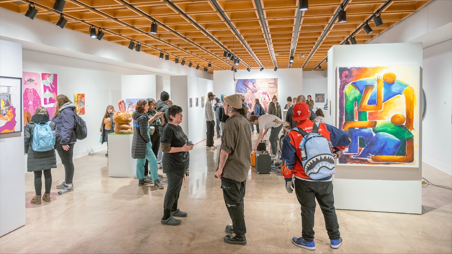 People talking and looking at art in a gallery