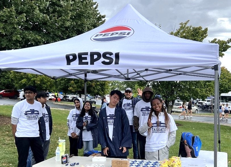 A group of students at a football game tailgate event.