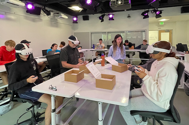 A group of students wearing virtual reality headsets in a classroom