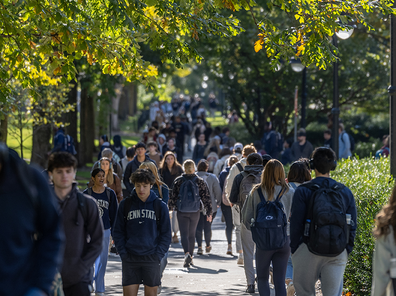 Students walk on Penn State's University Park campus in autumn