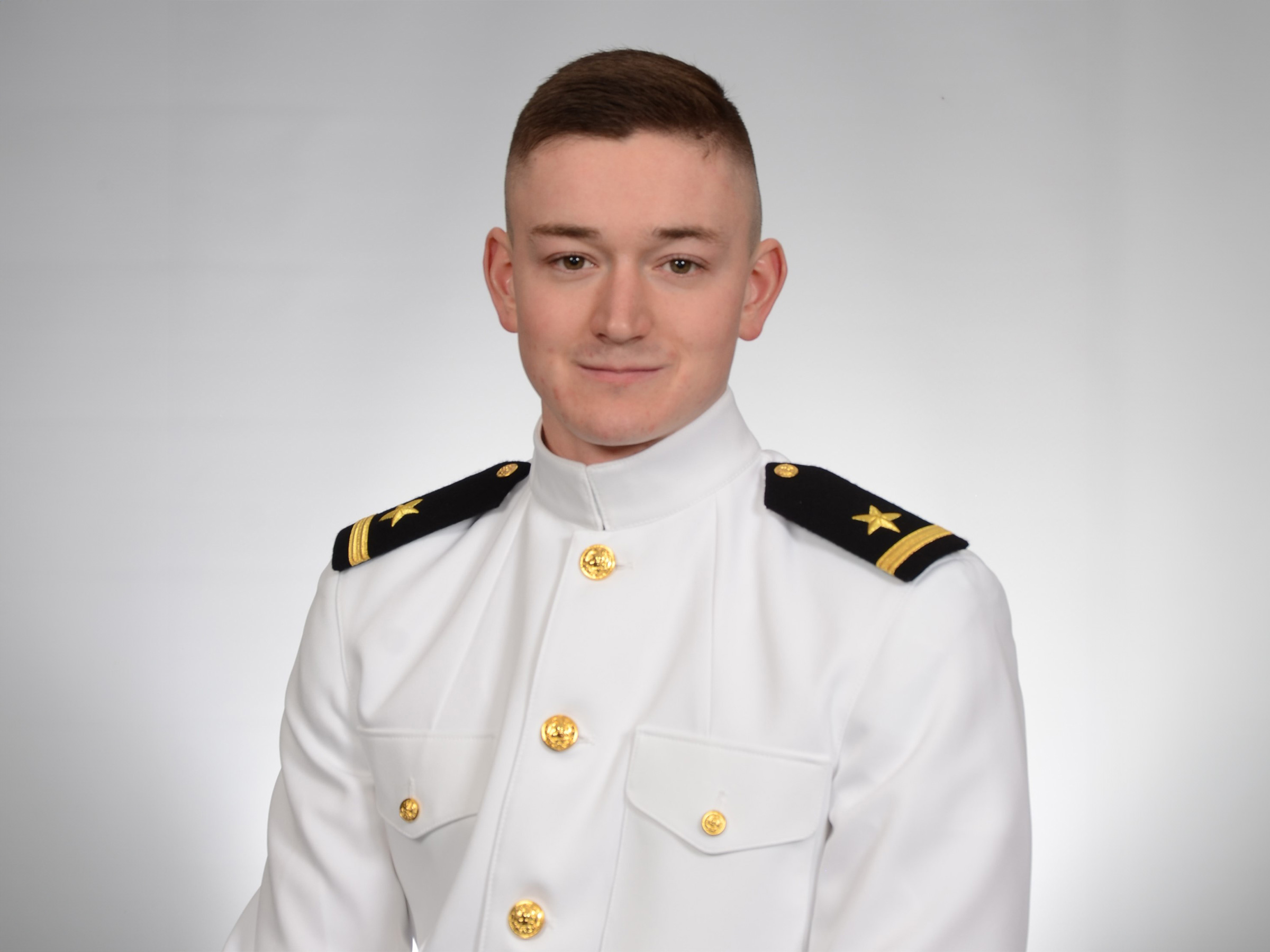 An individual in a military uniform poses for a formal portrait. 