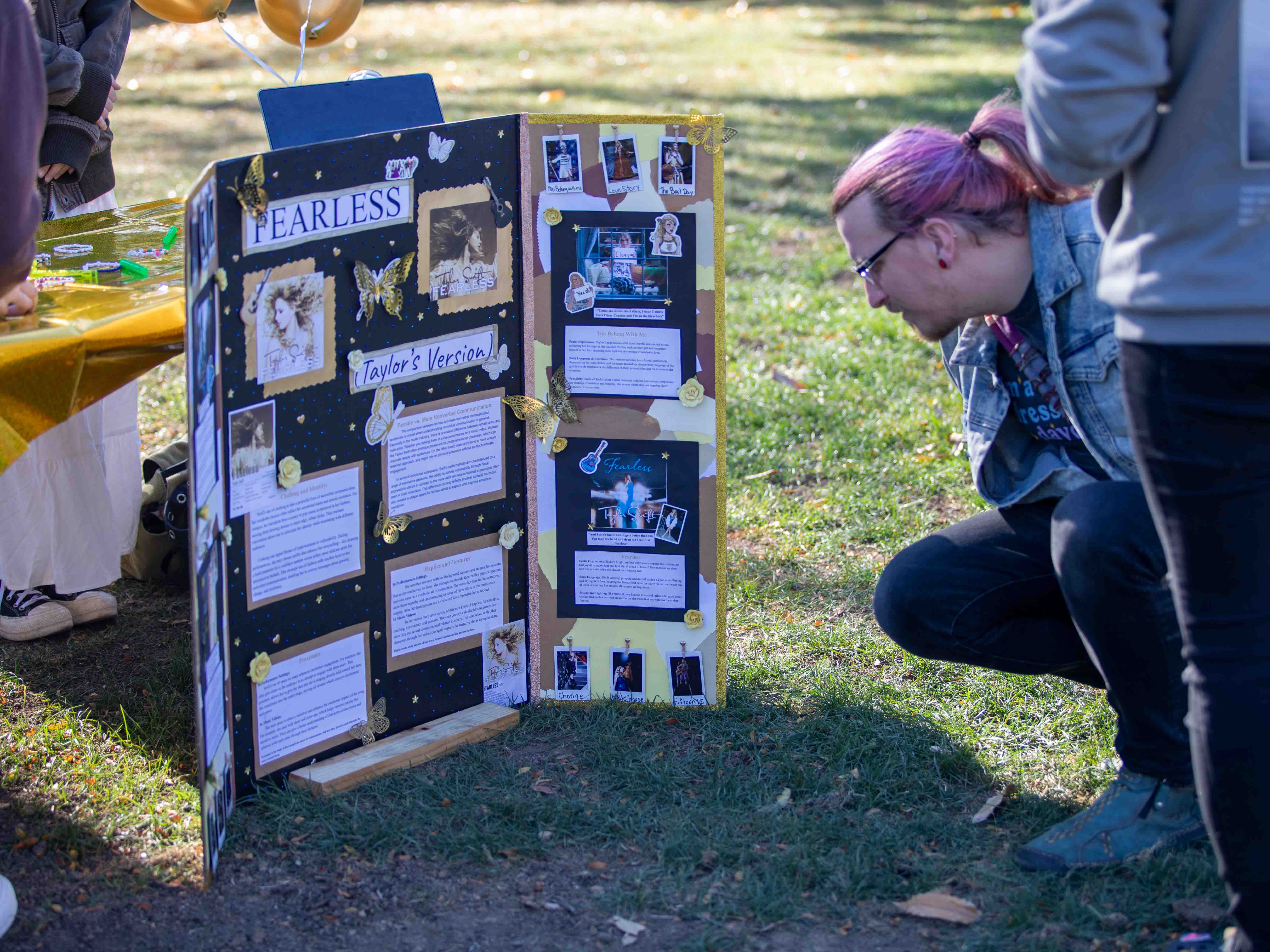 Community member reading student's research poster