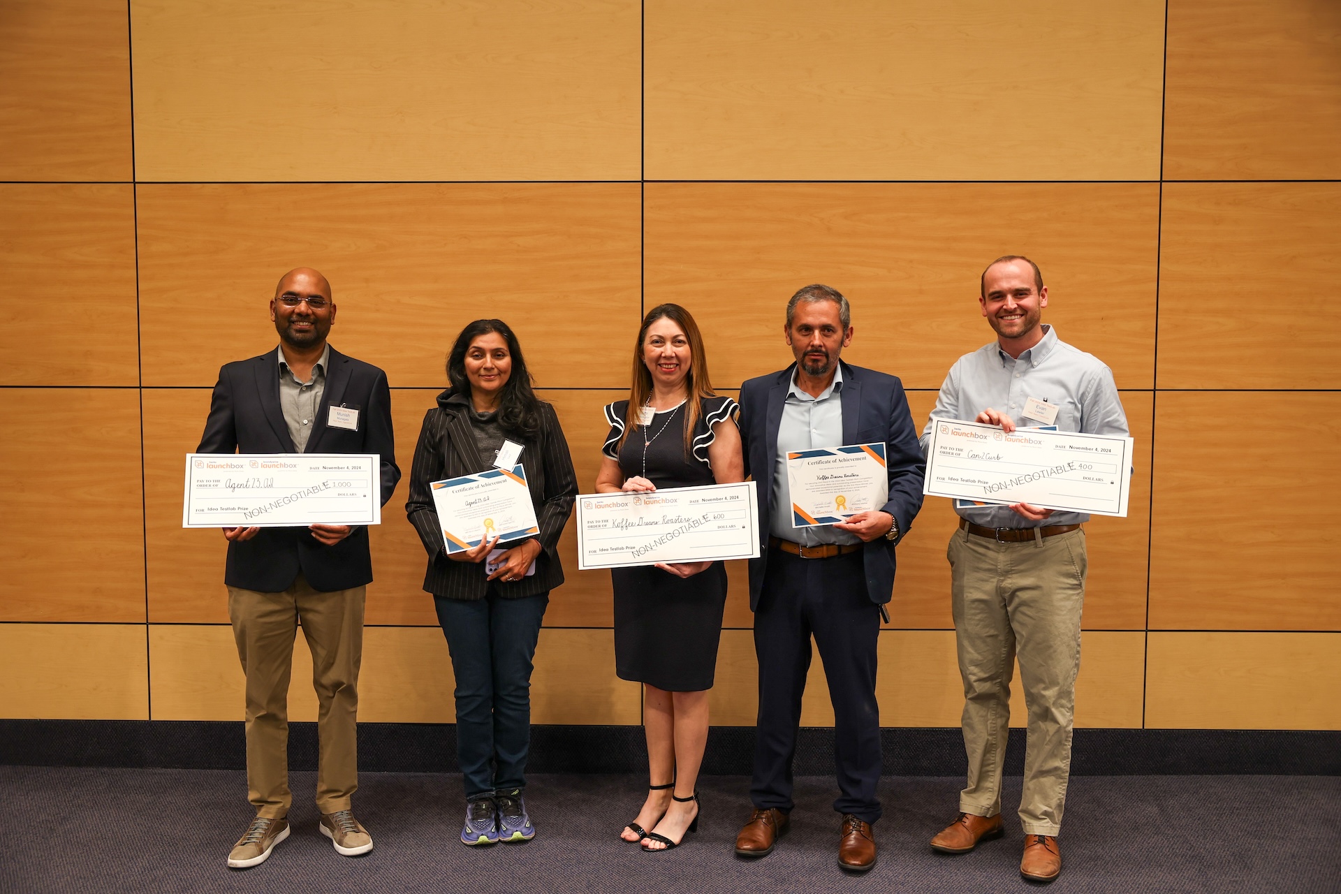 winners of idea testlab holding large checks