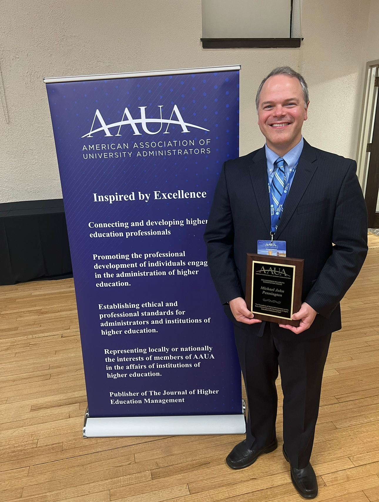 Michael J. Pennington holding an award