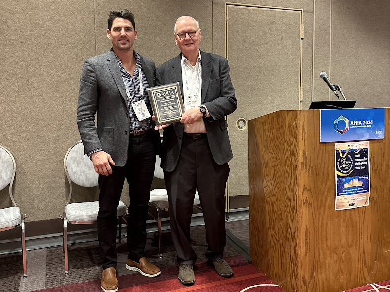 Stephen Kodish receiving his award from Dr. Henry Perry, Chairman of the APHA International Health Awards Committee