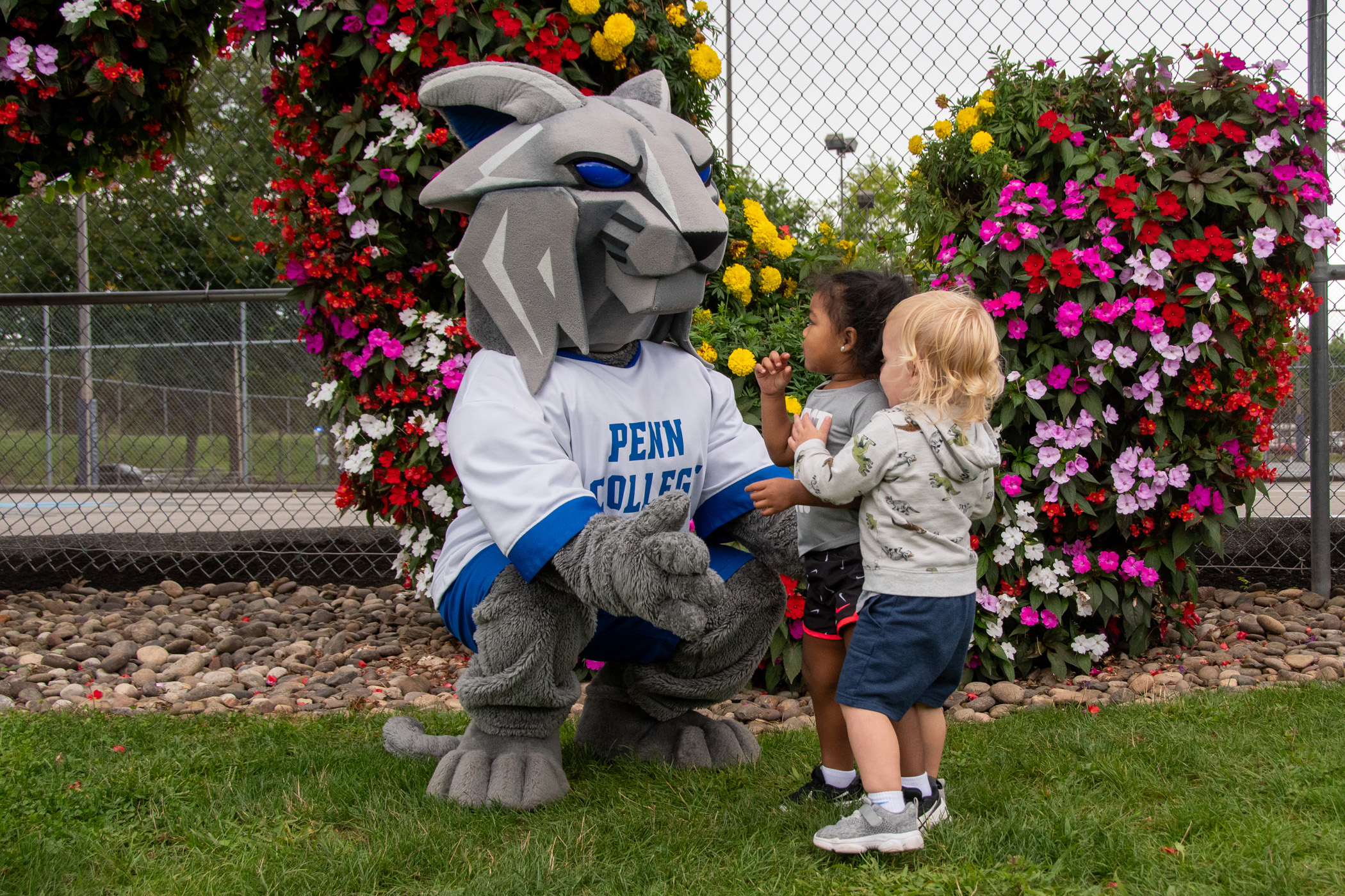 The Penn College Wildcat mascot greets children at the Children's Learning Center