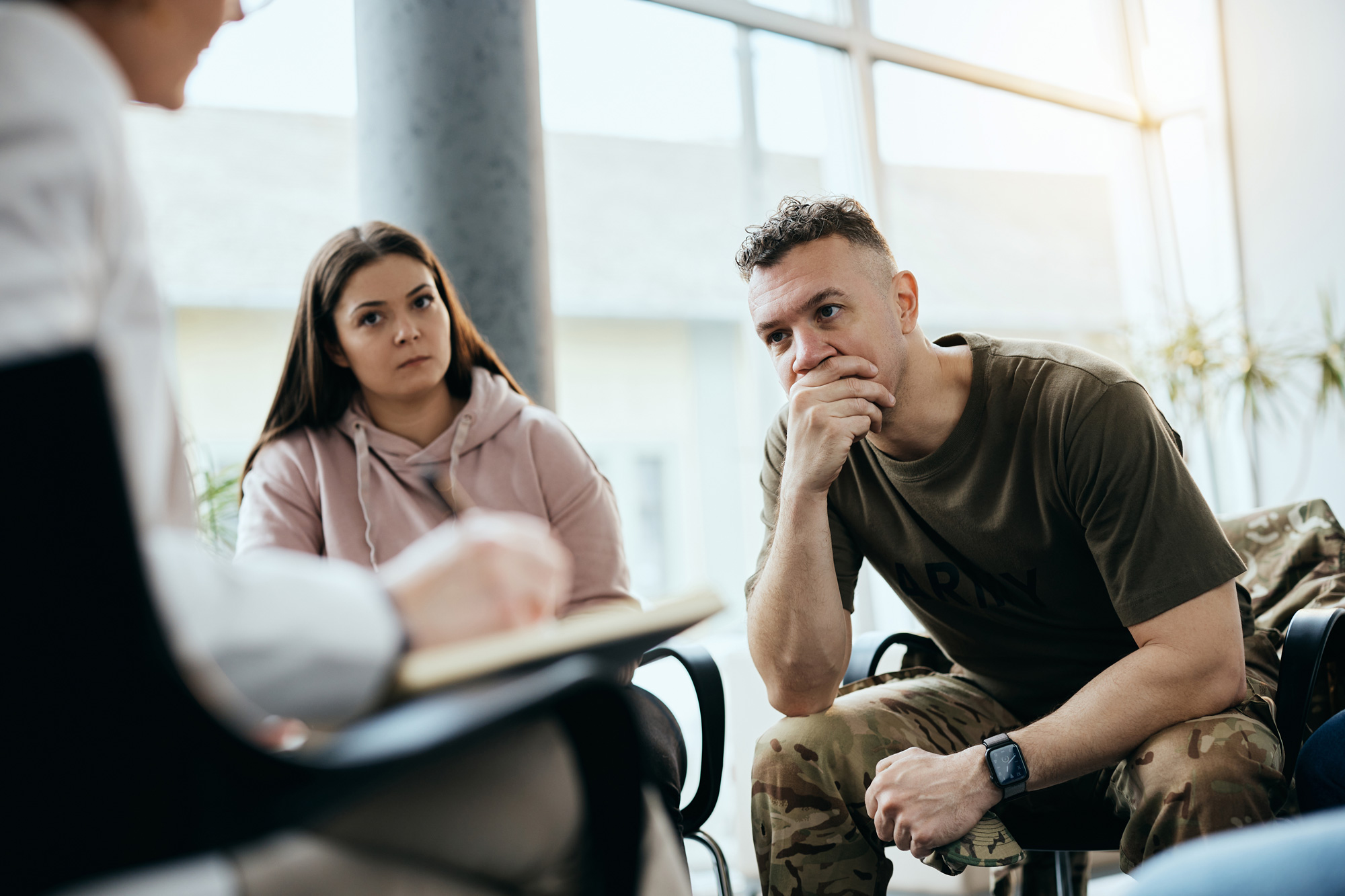 Military couple sitting with therapist