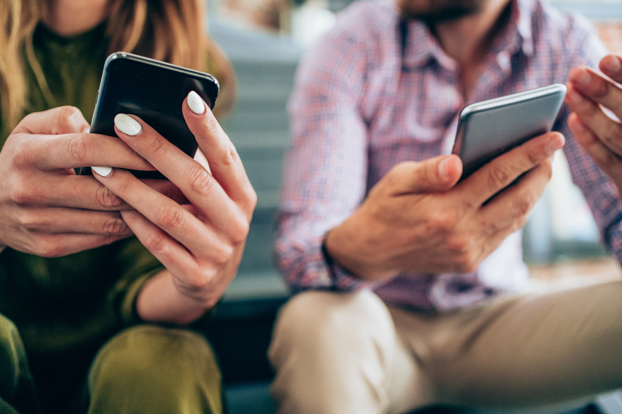 Two people holding smart phones