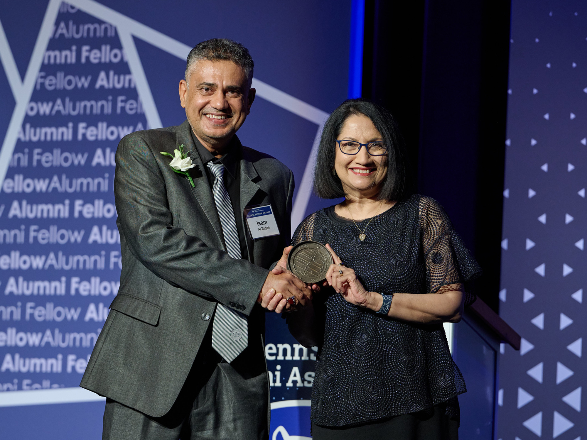 Isam Al-Zadjali accepts an alumni fellowship from President Neeli Bendapudi.