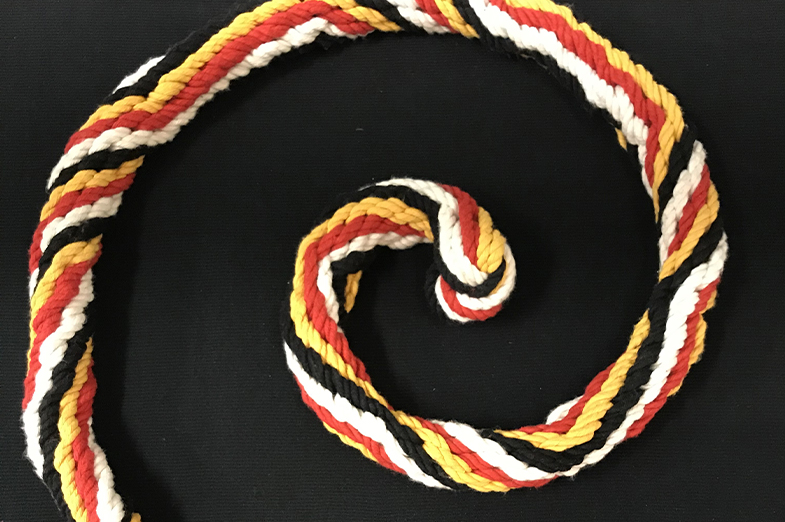 A spiral section of a rope with vibrant colors that was braided using ancient Incan techniques.