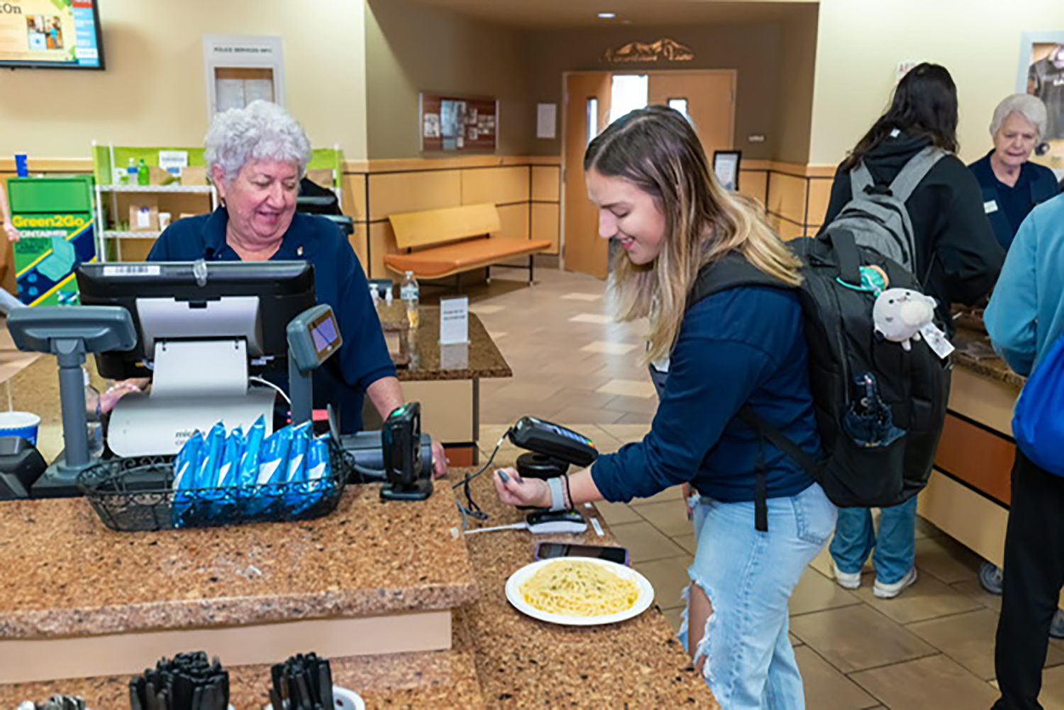 A Penn State student uses her mobile id+ card on her watch to pay in a Penn State dining common. 