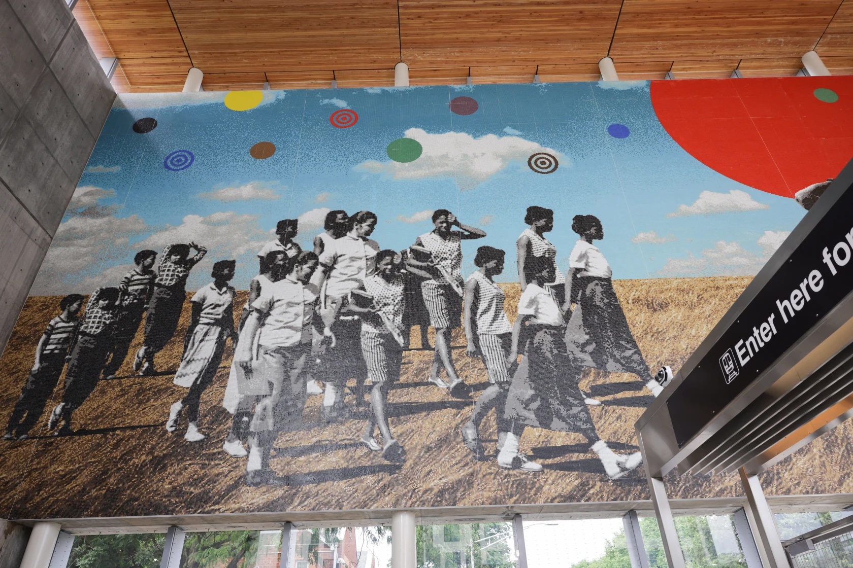 Mural showing people of color walking across a prairie