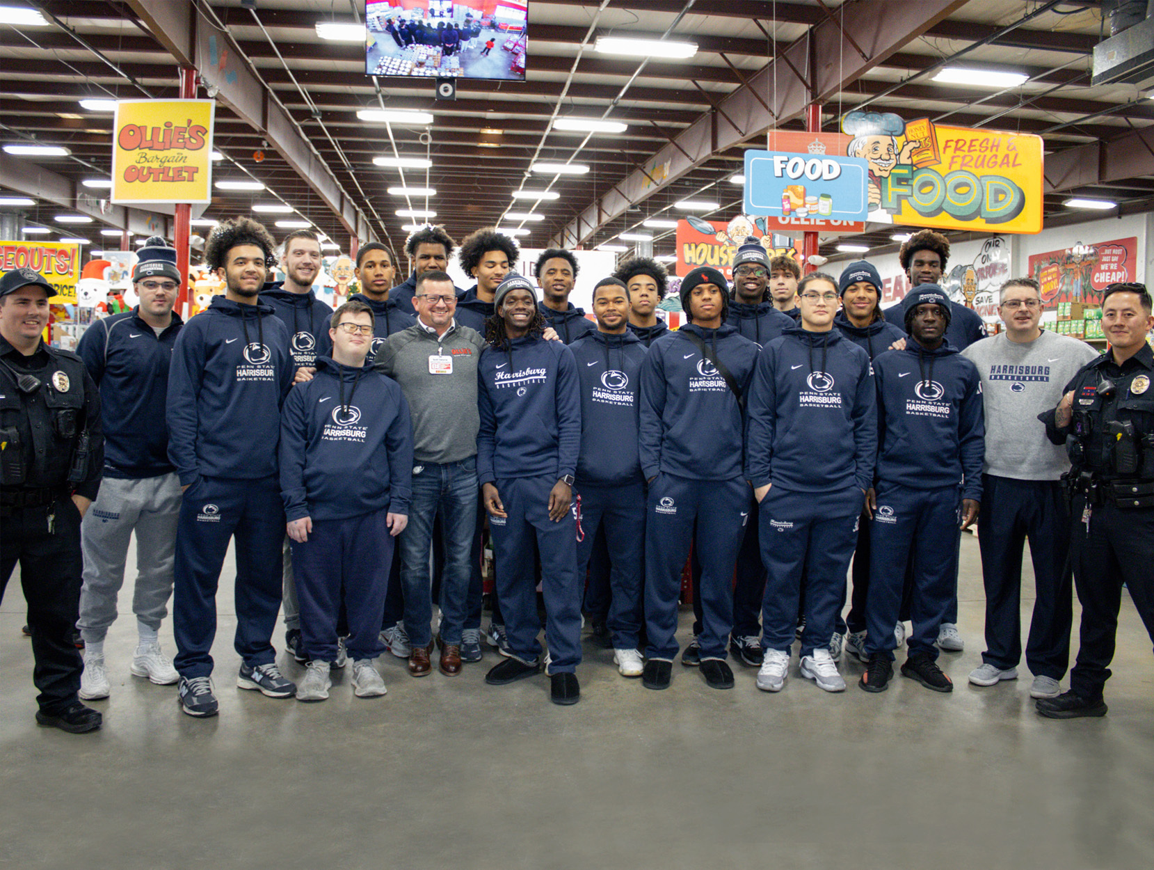 Group photo of Penn State Harrisburg basketball players with law enforcement officers