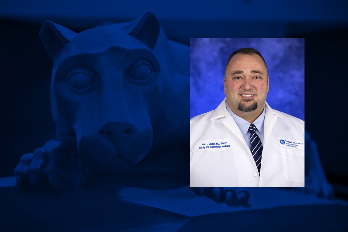 A photo of a man smiling is overlaid on a blue background with a statue of a lion