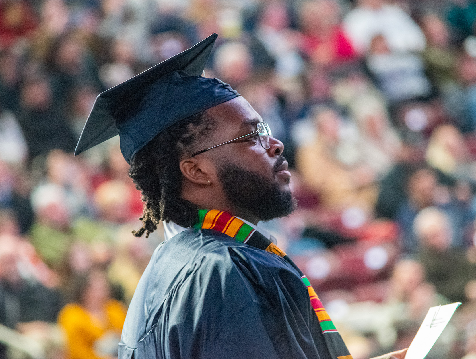 Profile of a graduate in cap and gown during fall 2024 commencement