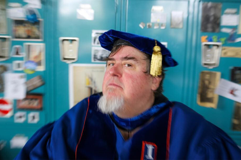 Selfie of a man wearing blue commencement regalia