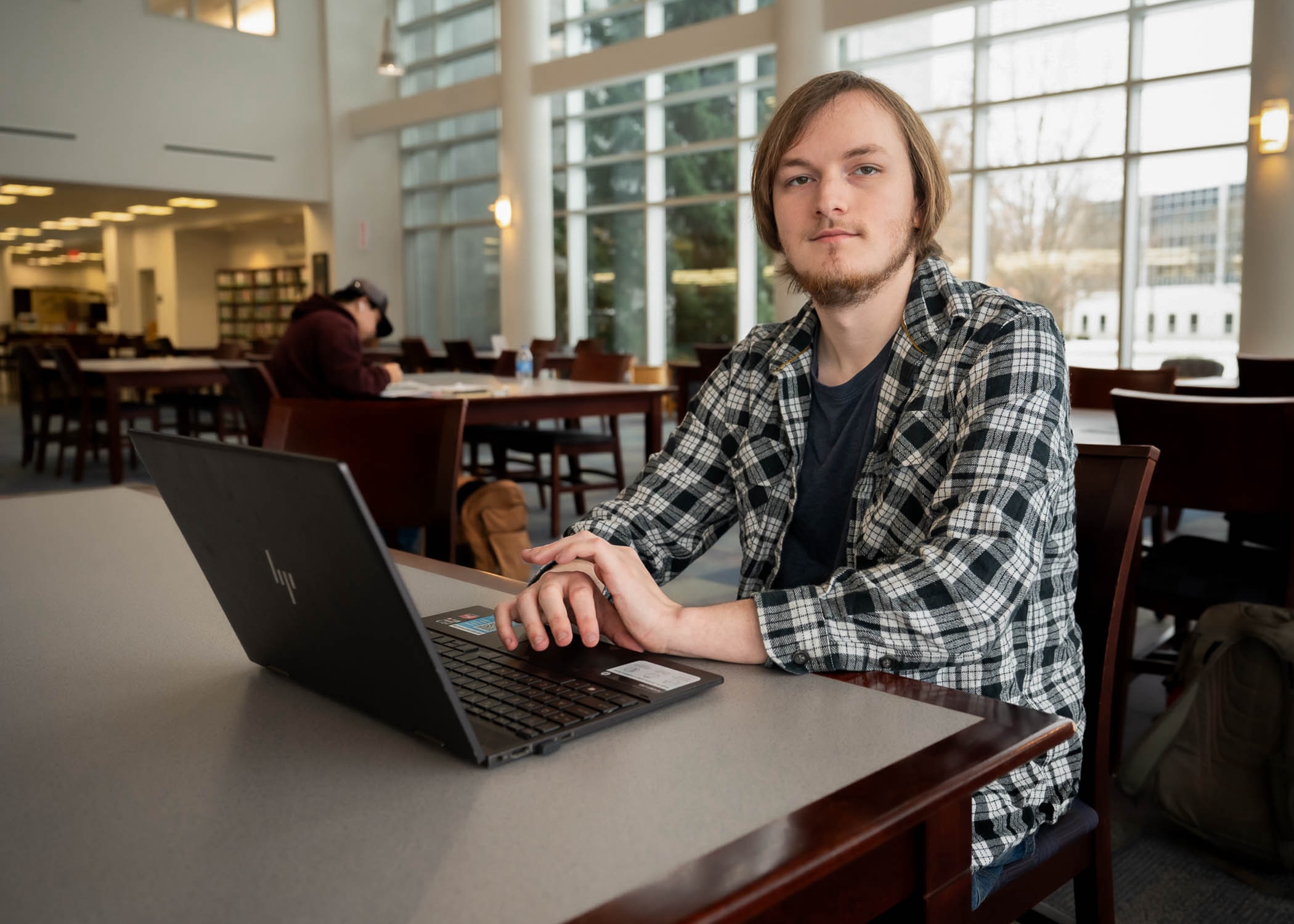 Dalton Nice sitting at a table with a laptop. 