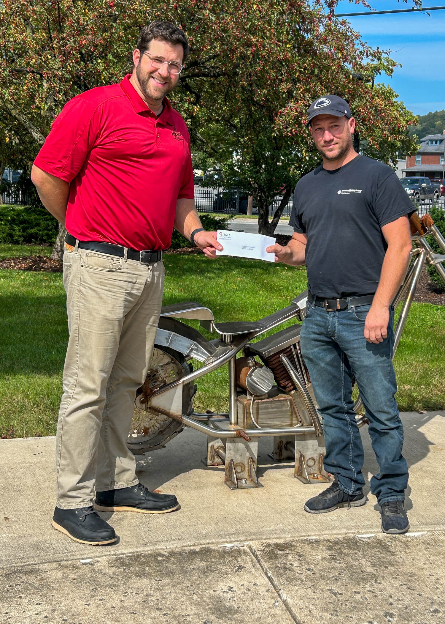 Two men stand next to a piece of metal equipment(Credit: Shanin L. Dougherty, Penn College) 