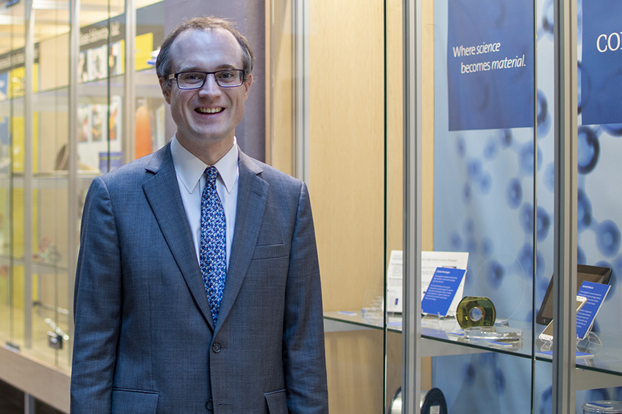 Glass expert John Mauro stands near a glass display