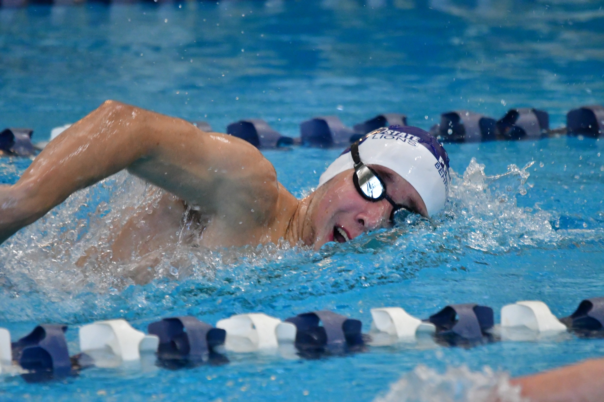 A male swimmer competes in a race for Penn State Behrend.